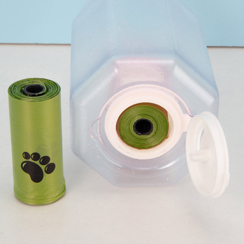 Green roll of dog waste bags with a white container on a light blue background